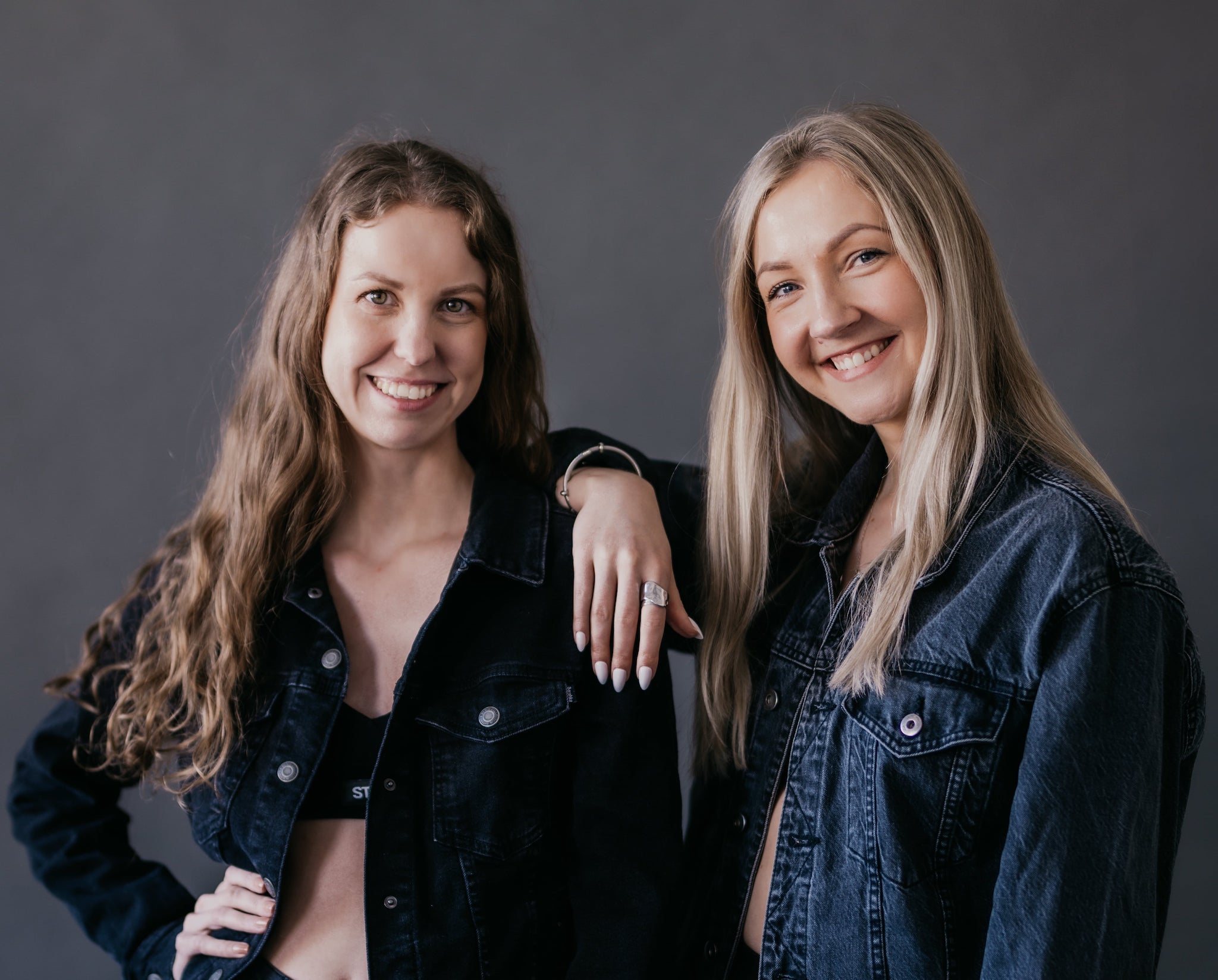 STEINY founders standing side by side against a dark background