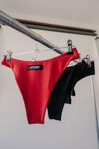 Red and black bamboo underwear hanging on a rack with 'STEINY' branding.