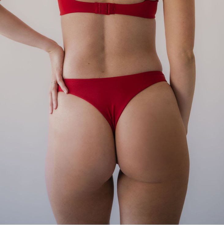 Person wearing a fiery red high-waisted thong